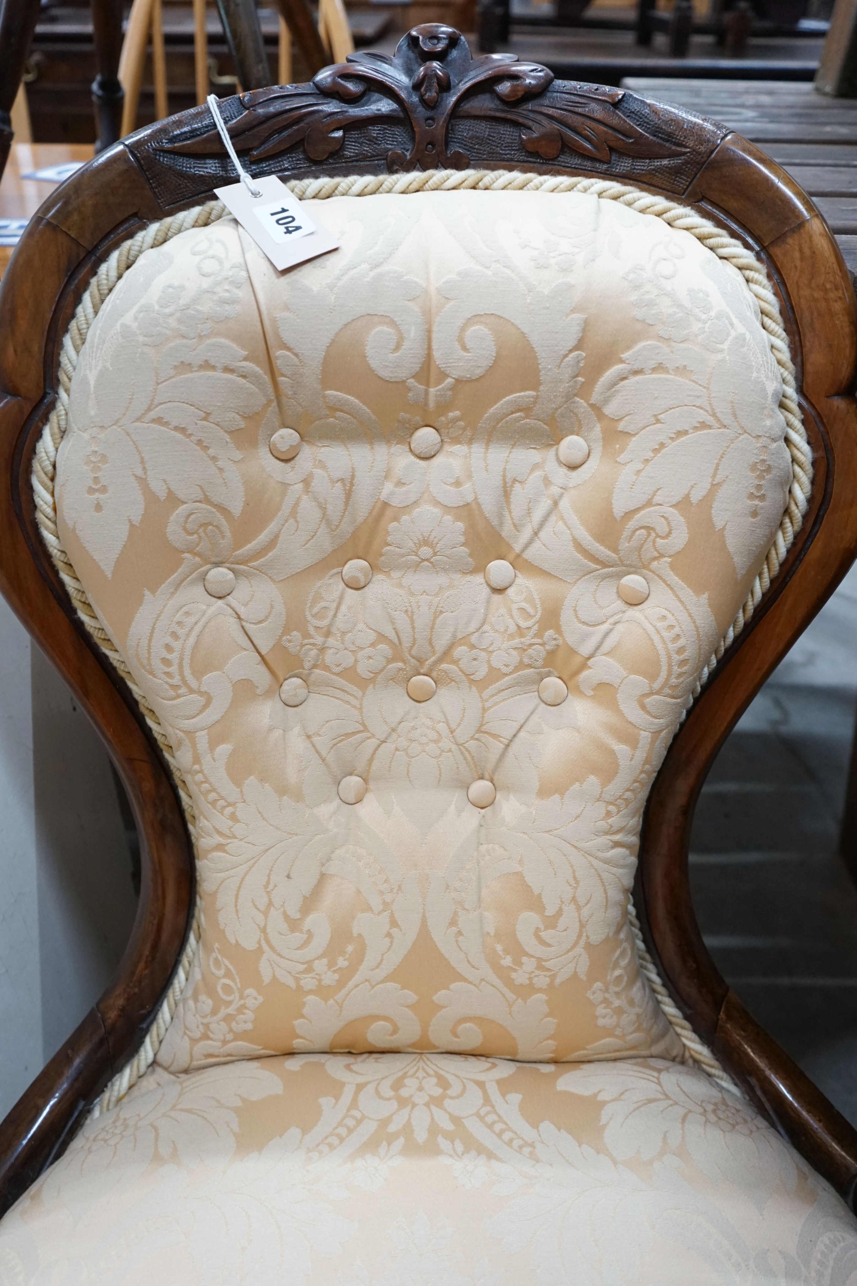 A Victorian walnut upholstered spoon back nursing chair